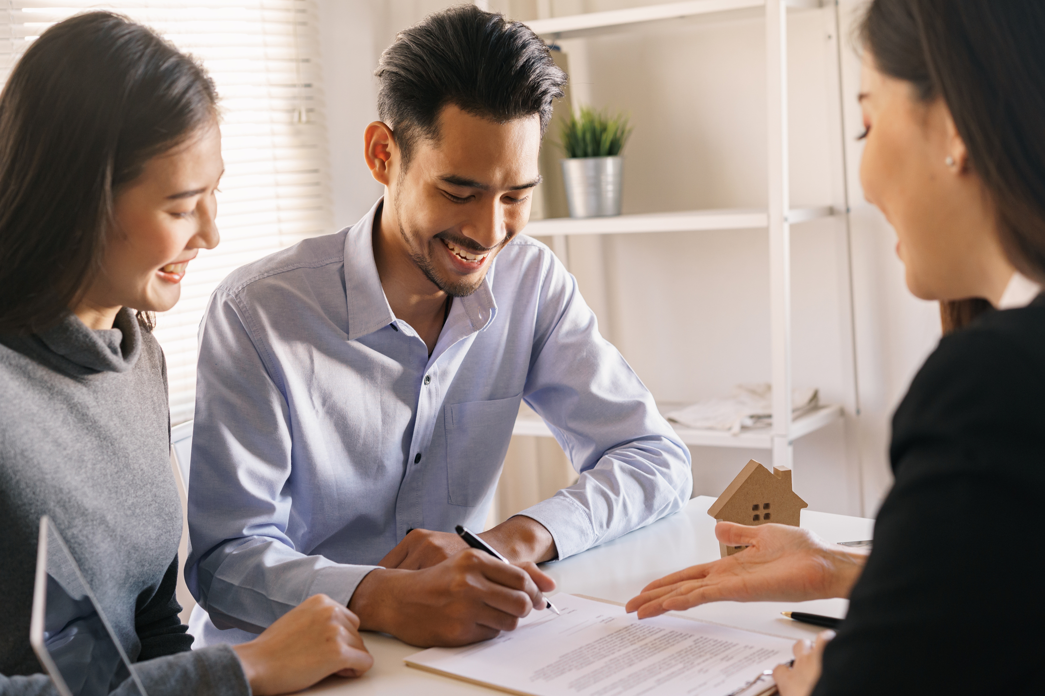 Medium shot couple holding small house